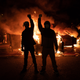 Demonstrators raise their fists as a fire burns in the street after clashes with law enforcement near the Seattle Police Departments East Precinct shortly after midnight on June 8, 2020, in Seattle, Washington.